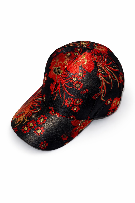 Floral Statement Cap featuring a vibrant red and gold floral pattern on a black background, unisex adjustable fit.