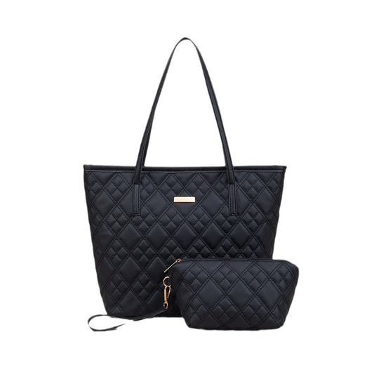 Black quilted Zaire Two-Piece Tote Bag Set featuring a large tote and a small pouch, both with gold accents.