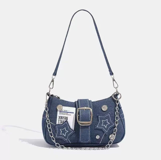 Midnight Star Denim Bag featuring a denim exterior, star embellishments, and a chain strap. Stylish and trendy design.