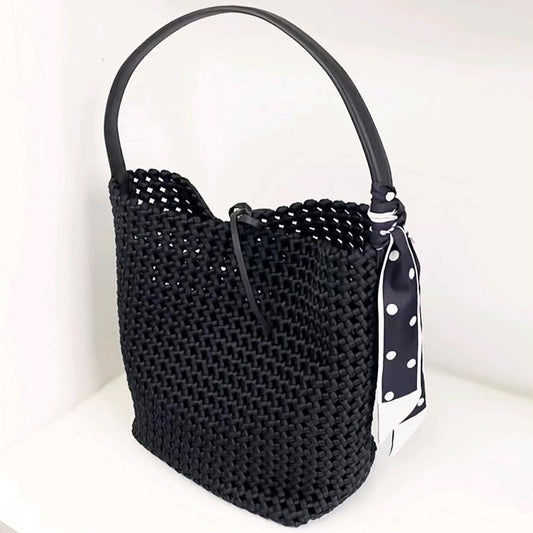 Woven Hollow Cowhide Leather Crossbody Handbag in black with a stylish polka dot scarf tied on the handle.