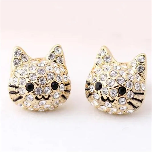 Gold cat-shaped stud earrings adorned with sparkling rhinestones, featuring a cute facial design with black accents.