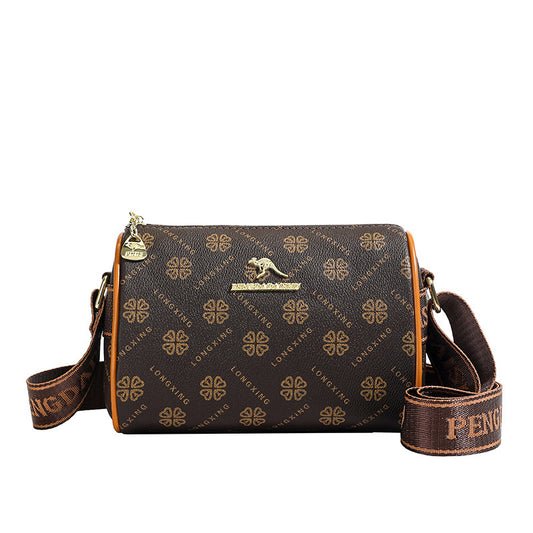 Monara Luxe Crossbody features a brown monogram design with a gold logo, adjustable strap, and elegant detailing.