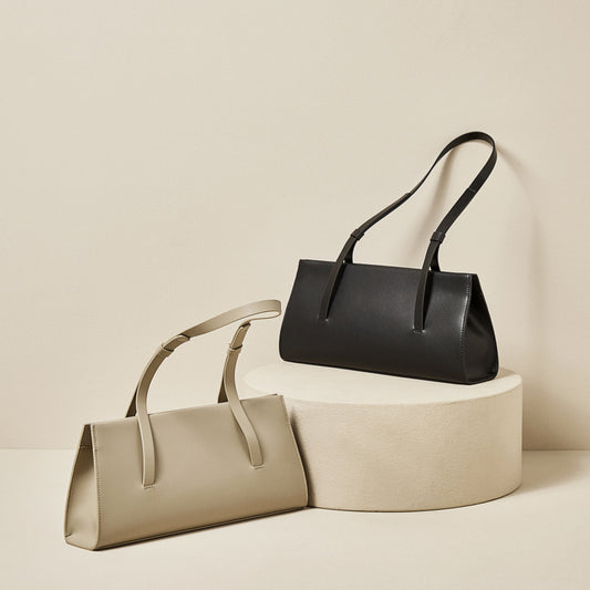 French Style Genuine Leather Shoulder Bag in beige and black, displayed on a round pedestal against a neutral background.