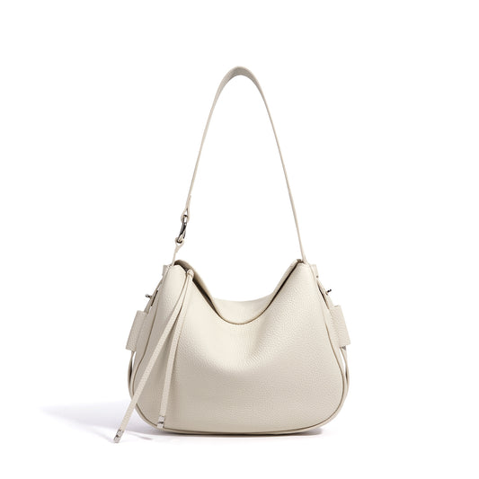 AriaLuxe Cote d'Ivoire Leather Crossbody in soft beige with a curved silhouette and adjustable strap.